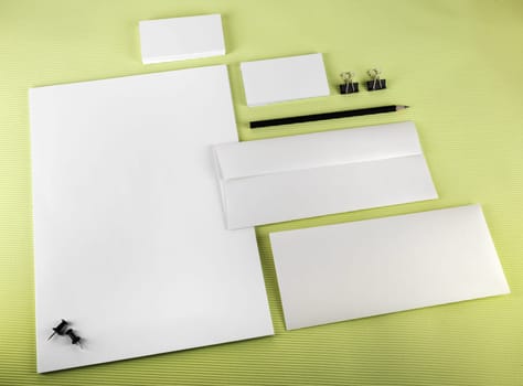 Corporate identity set on green background. Blank stationery.