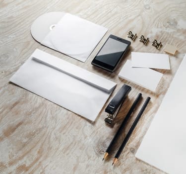 Photo of blank stationery set on light wooden background. Template for branding identity. Mock-up for graphic designers portfolios.