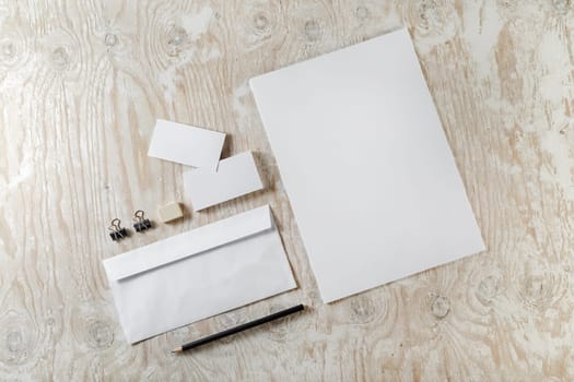 Blank stationery set on light wooden background. Mockup for design presentations and portfolios.