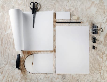 Photo of blank stationery and corporate identity template on light wooden background. Template for design presentations and portfolios.