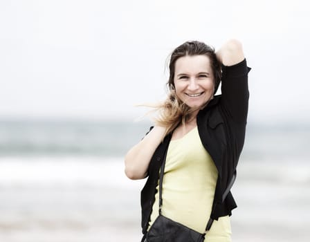 Happy smiling woman posing outdoor.. Selective focus on model.