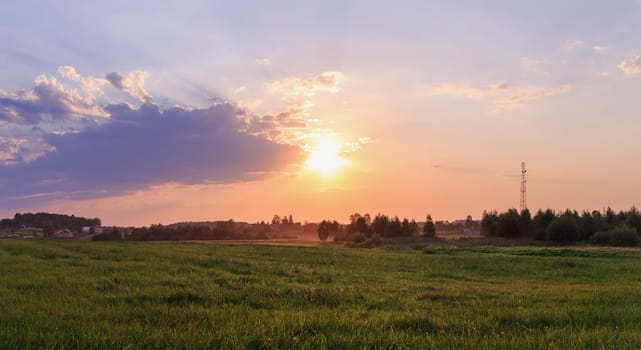 Bright colorful sunset in the countryside. Rural landscape.