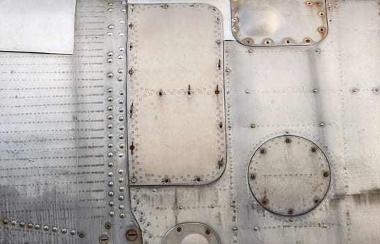 Abstract metal texture. Weathered vintage metal background with rivets . Sheathing old airplane.
