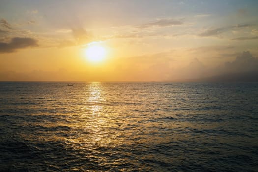 Beautiful seascape at sunrise. Reflection of the sun in the sea at dawn.