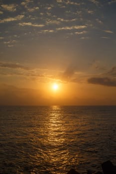 Bright sunrise over the sea. Vertical shot.