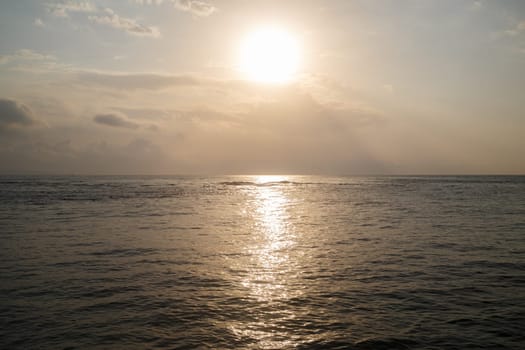Sunrise over the sea. Bright reflection in the water.