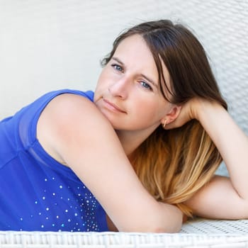 Close-up portrait of pretty young woman with long hair. Girl in a blue t-shirt. Selective focus on the model's face.