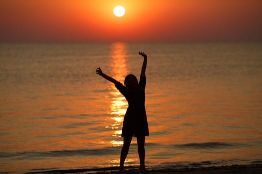 Woman enjoying the sunrise. Shallow depth of field.
