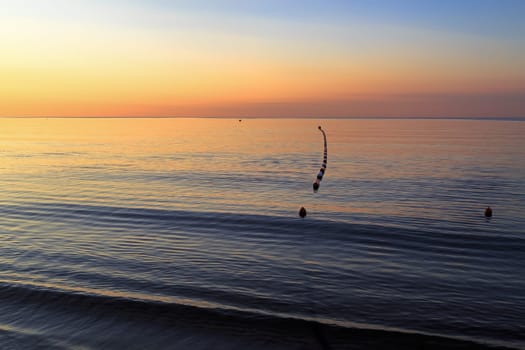 Bright colorful sunrise over the sea. Horizontal shot.