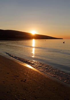 Sunrise over the sea. Sun reflection in sea. Vertical shot.