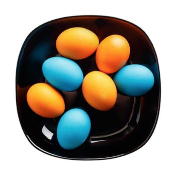 Colored Easter eggs on a black plate. Isolated with clipping path. Top view.
