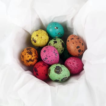 Colored Easter eggs on white background of wrapping paper. Top view.