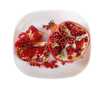 Pomegranate on a white rectangular plate. Top view. Isolated with clipping path.