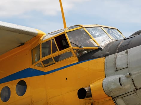 Cockpit old yellow airplane close up. Large fragment.