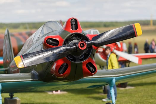 Old single-engine plane closeup. View of the propeller and the engine. View of the propeller and the engine. Shallow depth of field.