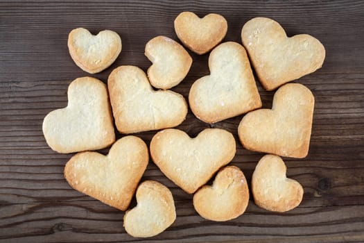 Heart shaped cookies on wooden background. Top view.