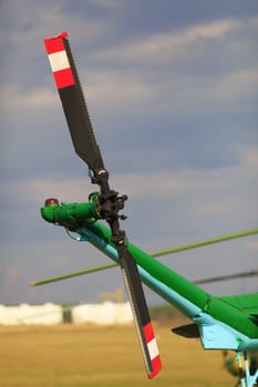 Close-up tail propeller of the helicopter against the sky.