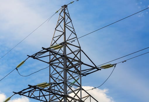 Electricity transmission pylon against blue sky. High voltage pylon.