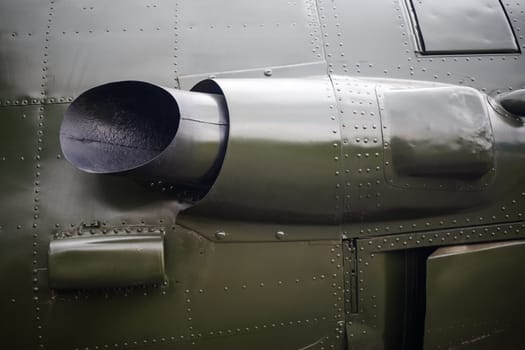 Close-up fragment of the old military plane. Fragment of old aircraft with rivets. Military background with rivets.