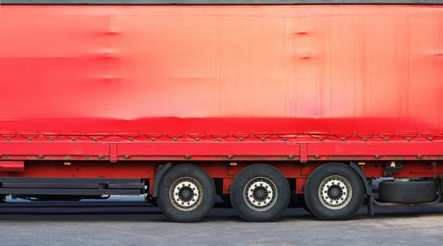 Close-up of the side of a big red truck. Space for text or image.