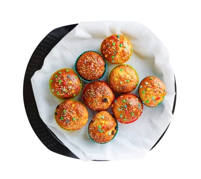 Appetizing delicious sweet homemade muffins on the tray isolated with clipping path on white background. Top view.