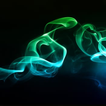 Abstract bright colored smoke on a dark background.