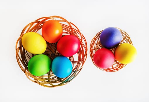 Colorful easter eggs. Two baskets with colored Easter eggs. Top view.