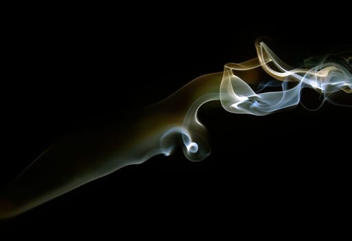 Abstract colored smoke on a dark background.