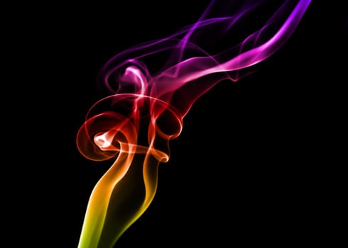 Abstract bright colored smoke on a dark background.
