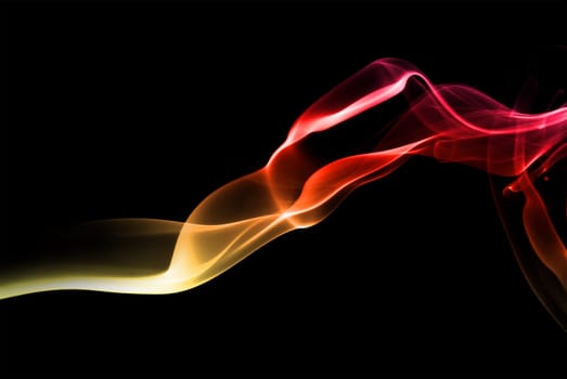 Abstract bright colored smoke on a dark background.