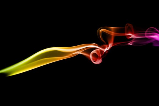 Abstract bright colored smoke on a dark background.