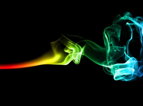 Abstract bright colored smoke on a dark background.