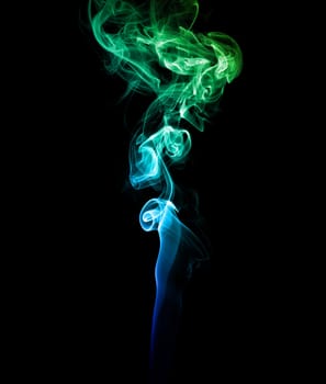 Abstract blue and green smoke on a dark background.
