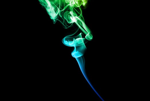 Abstract bright colored smoke on a dark background.