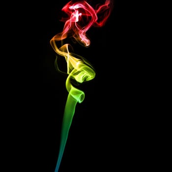 Abstract bright colored smoke on a dark background.