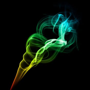 Abstract bright multicolored smoke on a dark background.