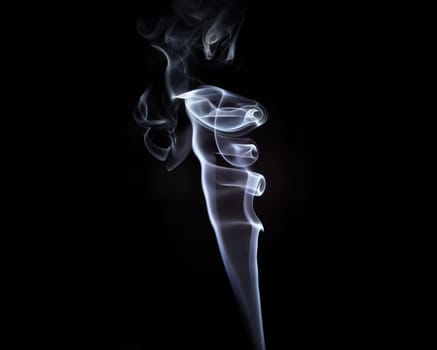 Abstract swirls of smoke on a black background.