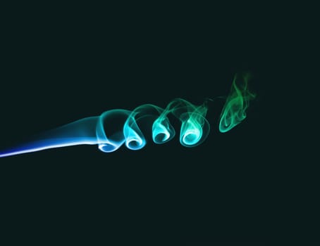 Abstract bright colored smoke on a dark green background.