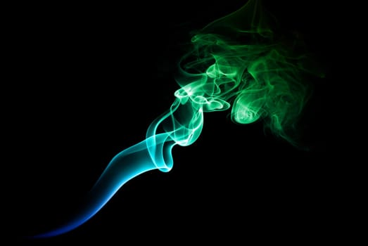 Green and blue smoke on a dark background.