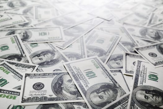 One hundred dollars pile. Money as background. Selective focus.