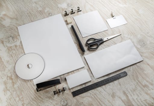 Corporate identity set on light wooden background. Blank template for design presentations and portfolios. Top view.
