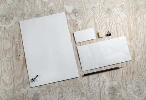 Blank stationery and corporate identity template on light wooden background.  Mock-up for graphic designers portfolios. Top view.