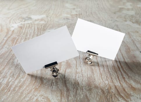 Blank business cards on light wooden background. Template for ID. Mock-up for branding identity.