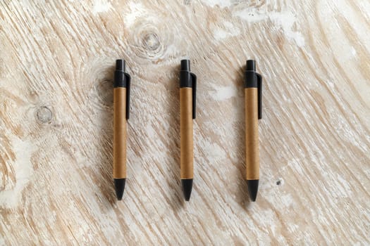 Set mechanical ballpoint pens on a wooden background. Template for design presentations and portfolios. Studio shot.