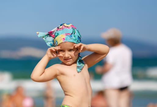 Portrait of a little girl in a headscarf. Focus on model. Shallow depth of field.