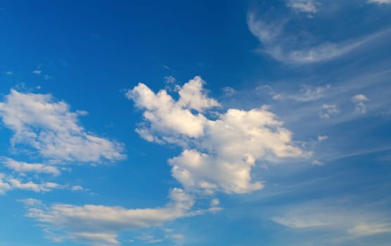 Bright blue sky with white clouds on a clear sunny day.