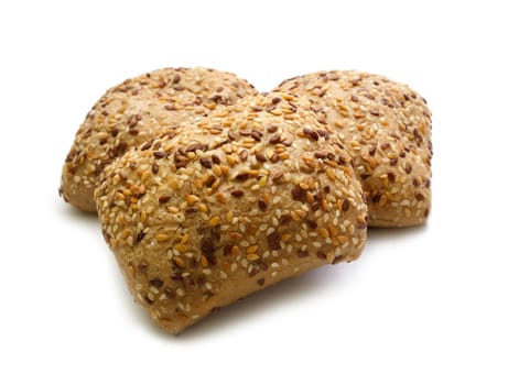 Tasty rolls with sesame seeds on a white background. Shallow depth of field.