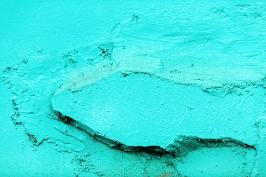 Weathered paint background. Old wall painted in bright turquoise color.