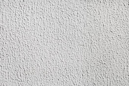 Detail of stucco cement wall painted in a light gray color. Abstract plaster texture background