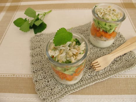 Salads in a glass with rice,barley,cucumber,carrot and yoghurt sauce